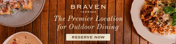 A promotional banner for Braven Terrace, described as “The Premier Location for Outdoor Dining.” The background is a warm wooden table. In the foreground are three plates: one with pasta topped with herbs, another with a baked dish garnished with green herbs, and a third with a dessert resembling ice cream sprinkled with nuts or chocolate. The text “BRAVEN” appears in large letters at the top, with “Terrace” and the tagline below. A “RESERVE NOW” button is displayed at the bottom. The overall design is elegant and inviting, encouraging outdoor dining reservations.